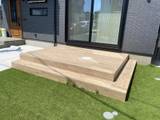 芝生に調和する木目調テラスデッキの施工