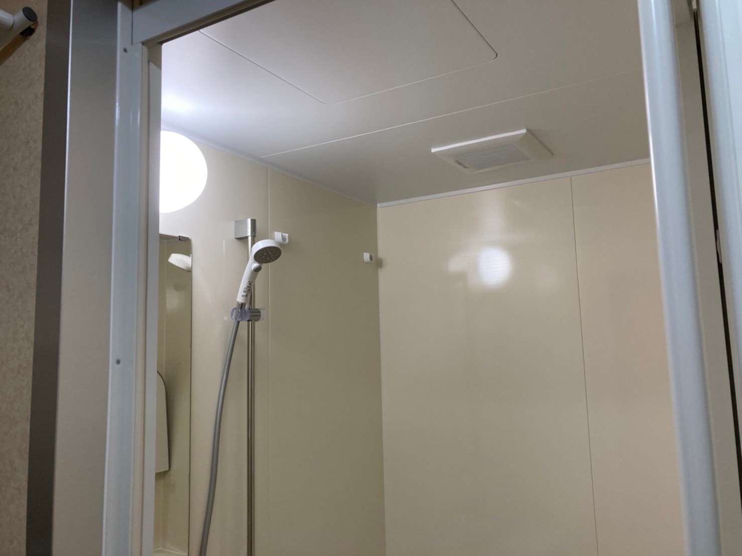 ベージュの壁と床で優しい雰囲気の浴室に。